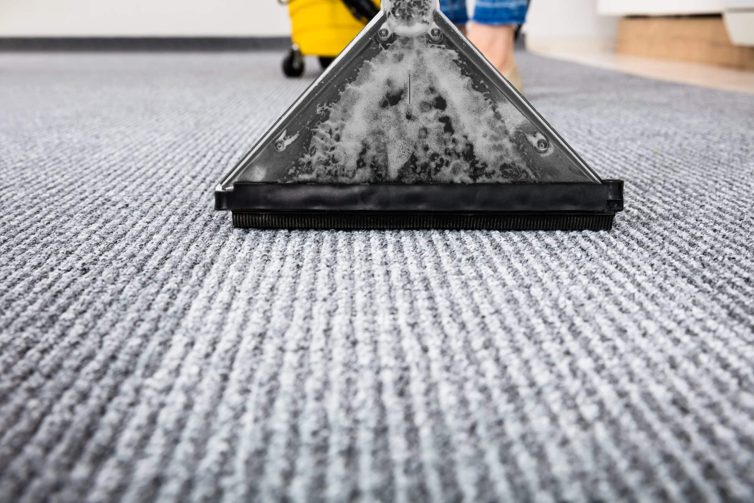 Close-up Of A Cleaning Carpet With Vacuum Cleaner