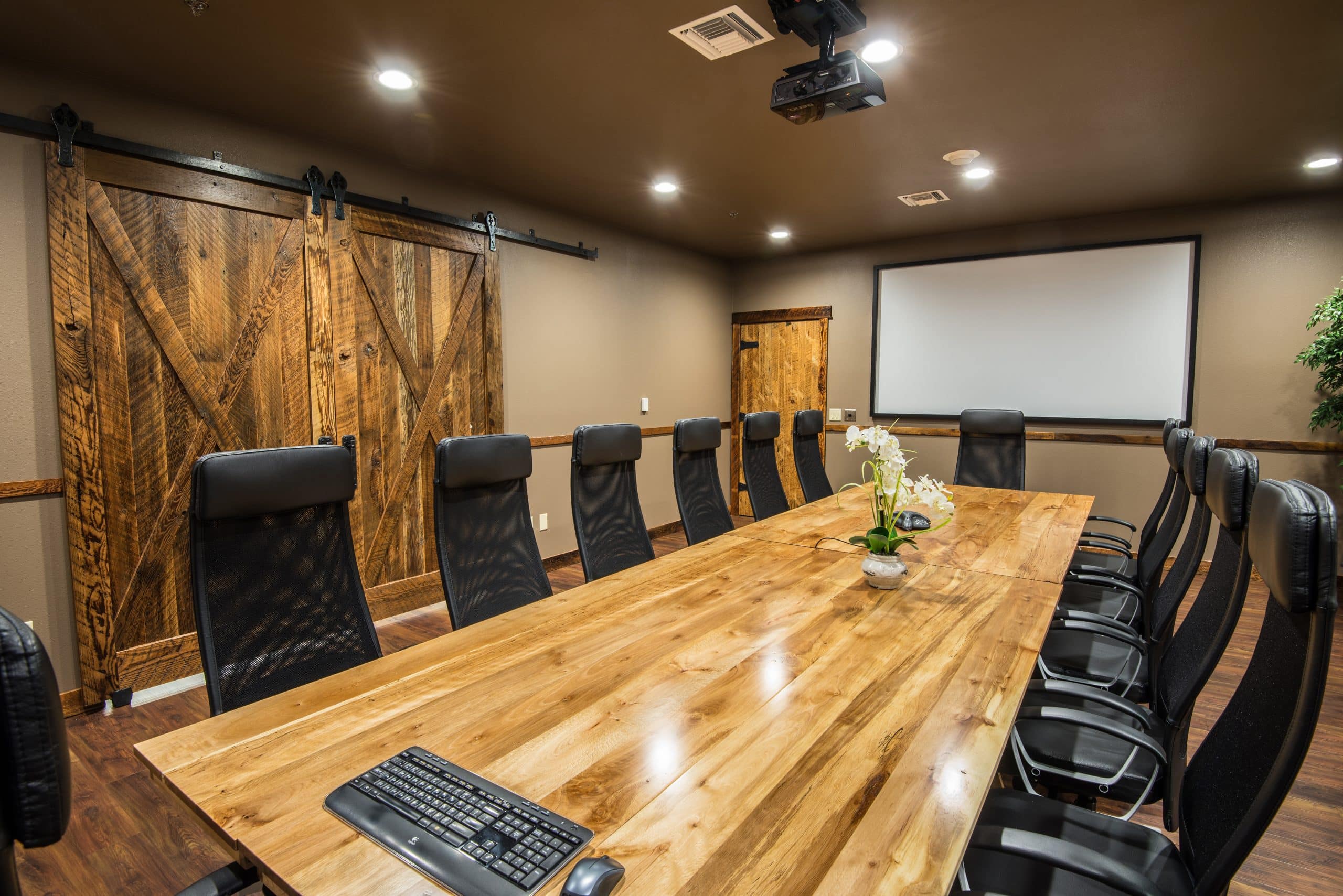 An empty conference room with a large wooden table